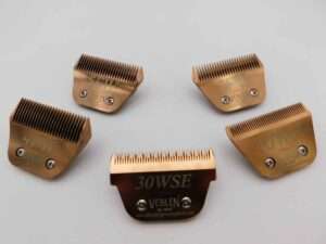 Five bronze hair clipper guards on white background.