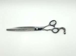 Professional hair thinning scissors on white background.