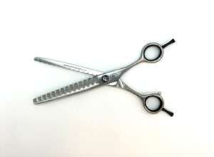 Professional texturizing hair shears on white background.