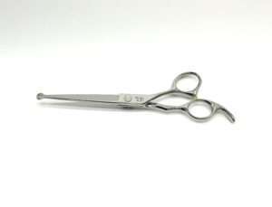 Professional hairdressing scissors on white background