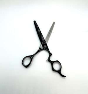 Professional hairdressing scissors on white background.