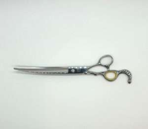 Decorative handle professional hairdressing scissors on white background.