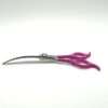 Purple-handled curved grooming scissors on white background.