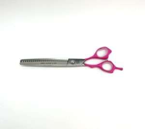 Pink-handled thinning shears for hairdressing.