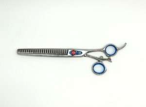 Silver hair thinning scissors on white background.