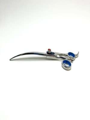 Curved silver hairdressing scissors on white background