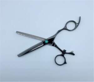Professional hair thinning scissors on white background.