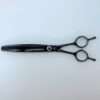Black hair thinning scissors on white background.