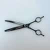 Professional hair thinning scissors on white background.