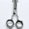 Professional hair thinning scissors on white background.