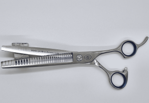 Professional hair thinning shears on white background.