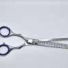 Professional hair thinning scissors on white background.