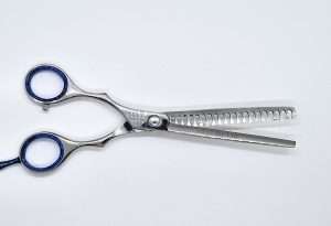 Stainless steel hair thinning scissors with blue grips.