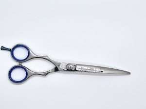 Silver hairdressing scissors on white background.