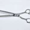Silver hair thinning scissors on white background.