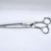 Silver hairdressing scissors with ornate handles.