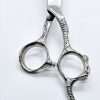 Intricate barber scissors on white background.