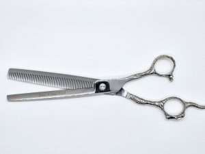 Silver hair thinning scissors on white background.
