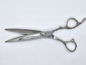 Professional hair cutting scissors on white background