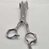 Vintage metal scissors on a wooden block.