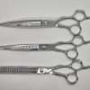 Three professional hair cutting scissors set.