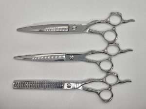 Three professional hair cutting scissors set.