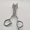 Professional haircutting scissors on wooden block