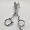 Professional hair styling scissors on wooden stand