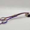 Colorful hair thinning scissors displayed on stand.