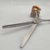 Silver-textured barber thinning shears on white background