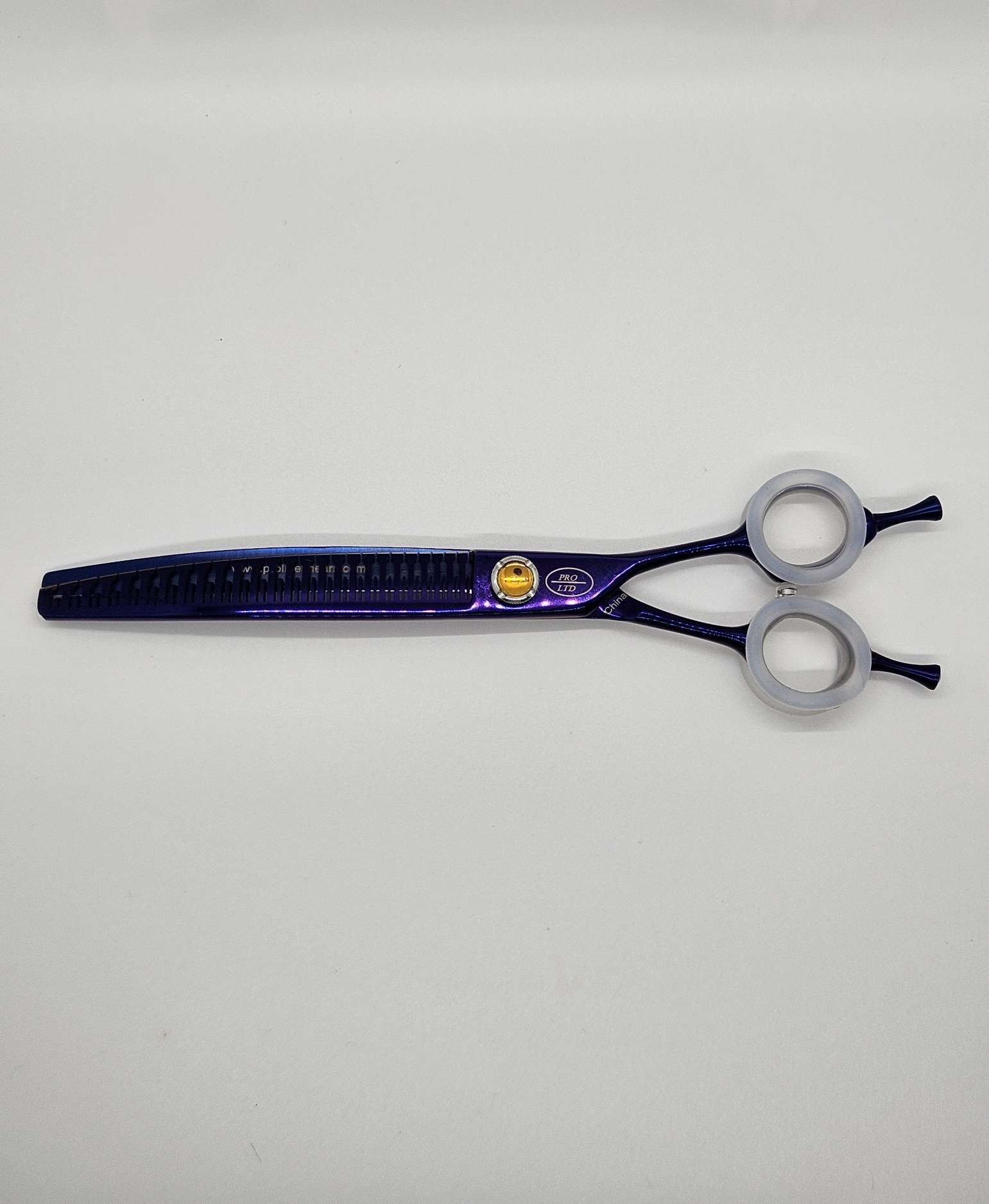 Purple hair thinning shears on white background.